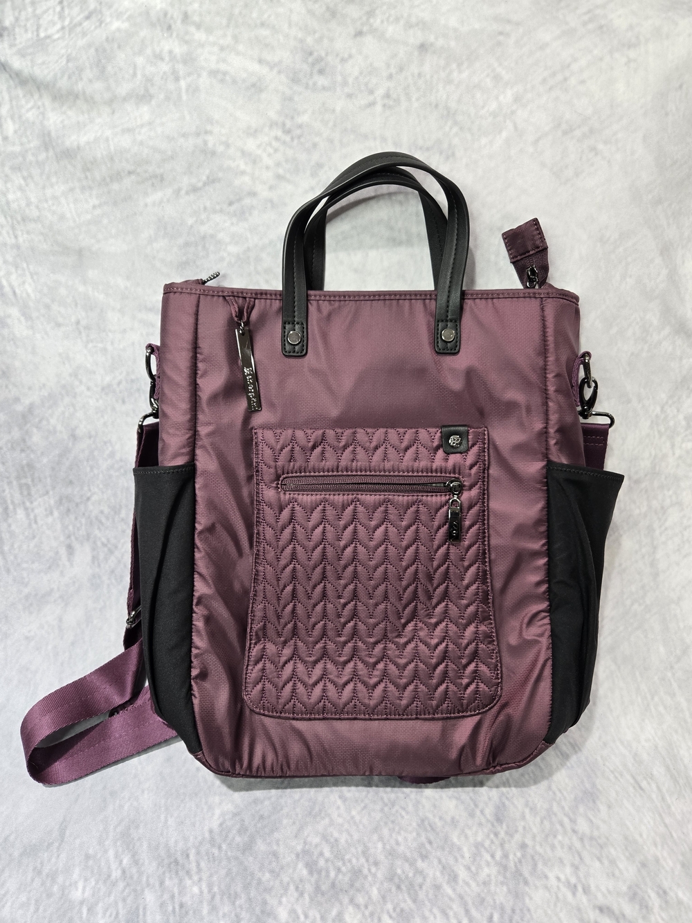 Sherpani Soleil LE convertible anti-theft tote bag in a quilted purple fabric.